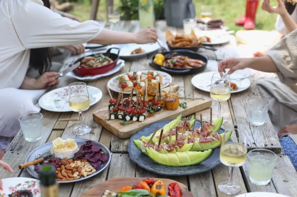 group-of-people-eating-on-backyard